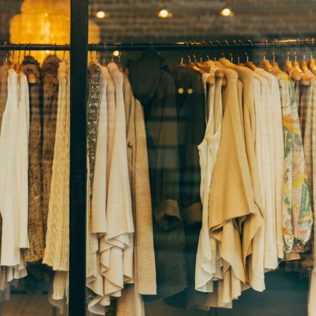 Clothing rails in a lit shop interior