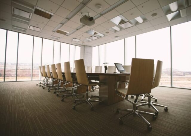 A meeting room with the chairs empty