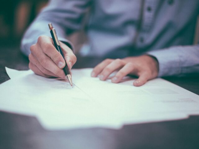 Working papers and a pen on a desk
