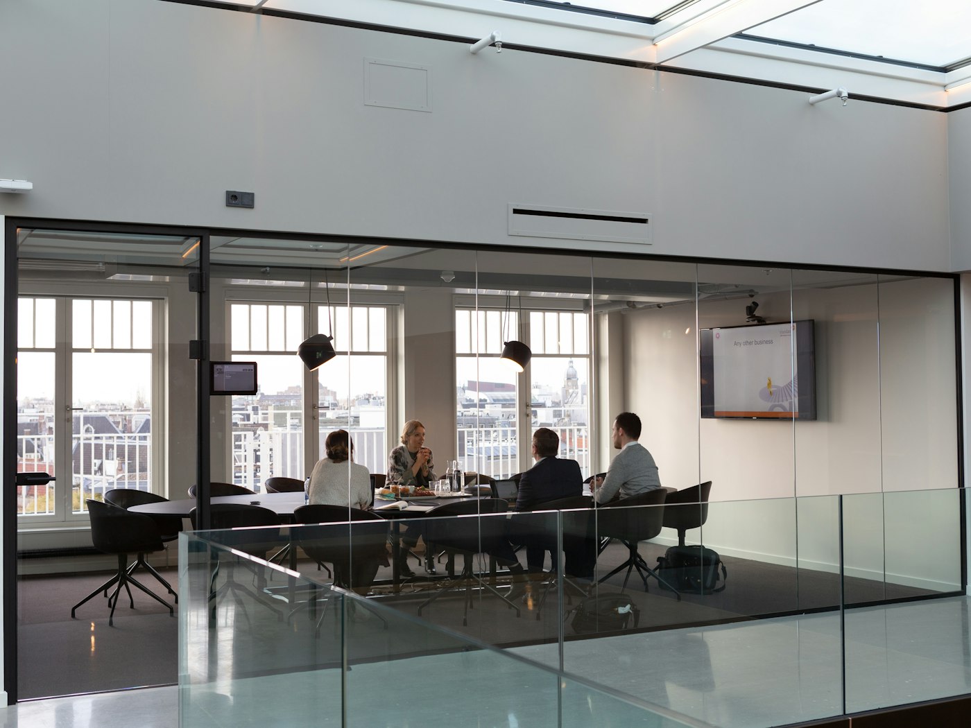 A glass-walled meeting room in an office