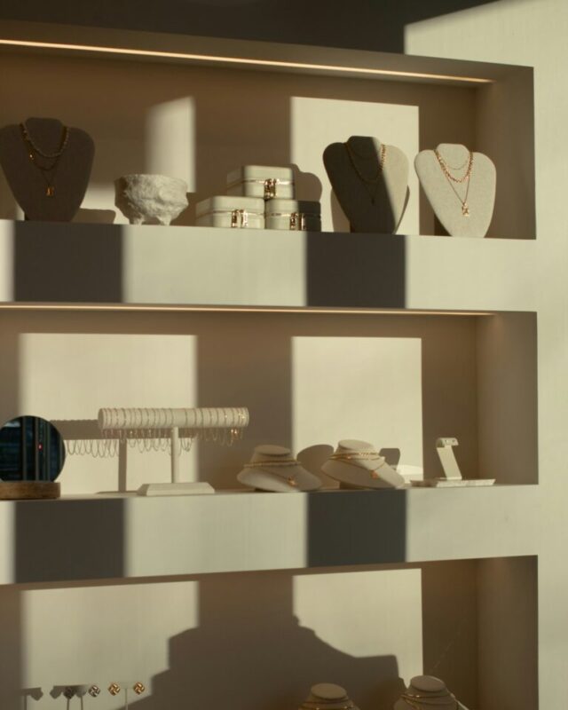Jewellery on display stands, lit from the side