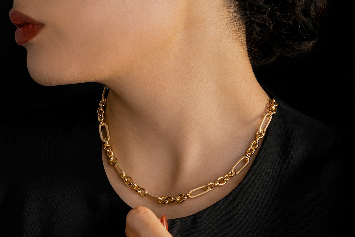 A gold chain worn at the neck