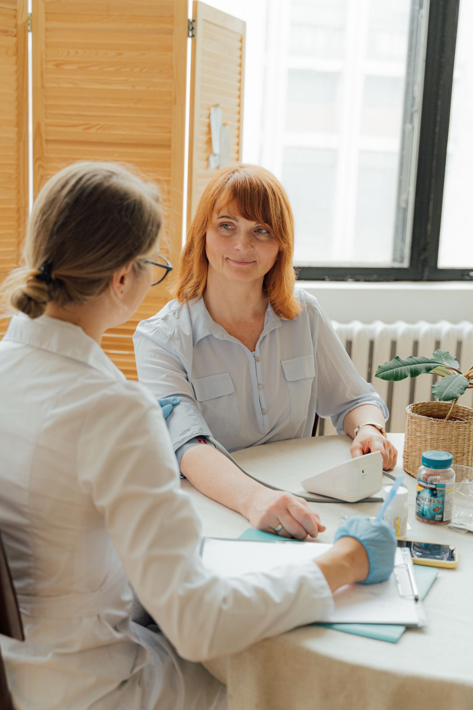 A patient speaking with a doctor at a desk