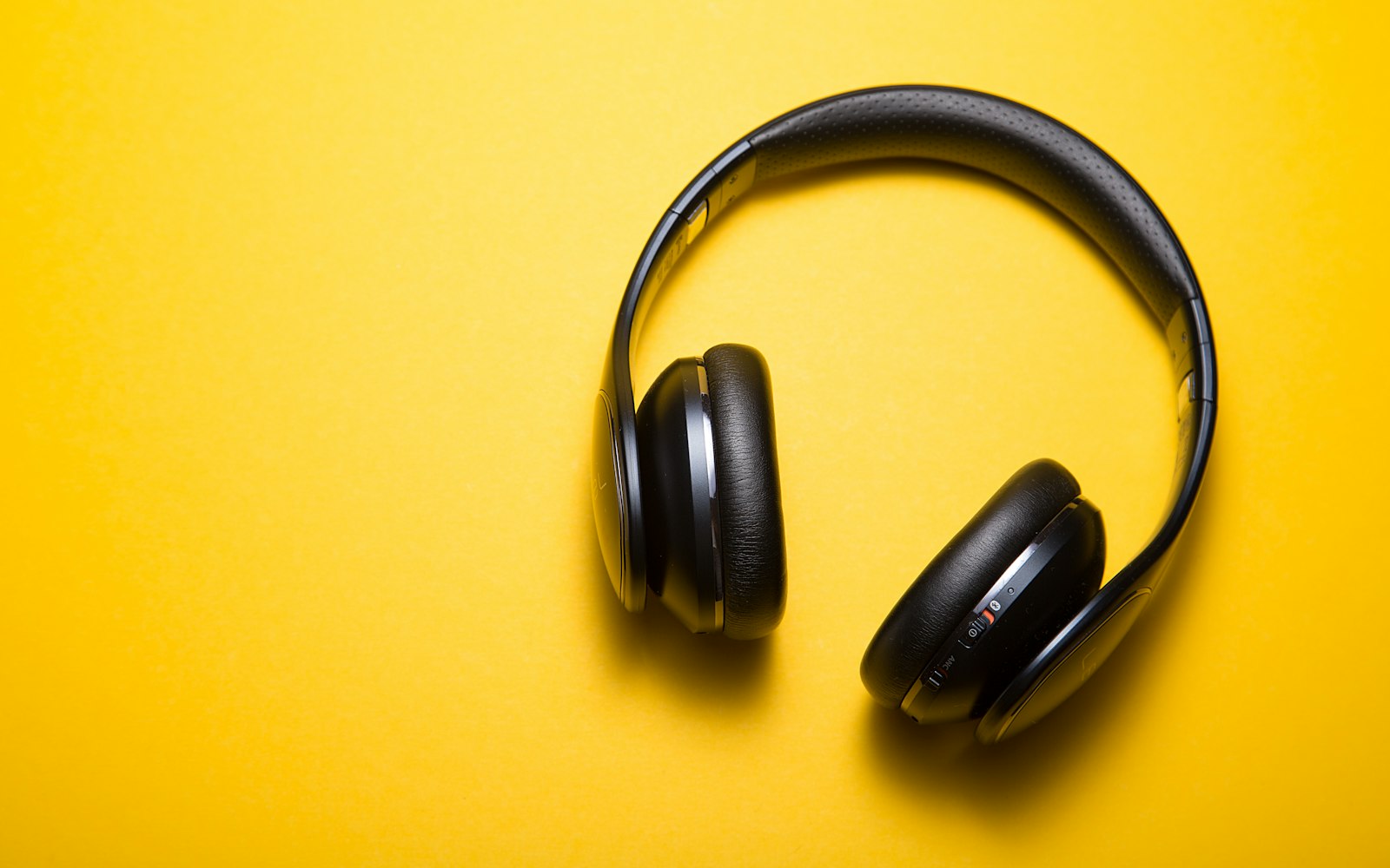 Over-ear headphones on a plain ground