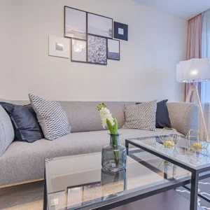 Contemporary living room featuring a gray sofa, geometric decor, and framed art.