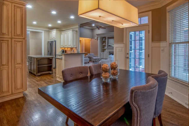 A wooden dining table and chairs in a warm interior
