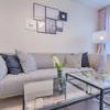 Contemporary living room featuring a gray sofa, geometric decor, and framed art.